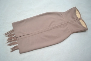 Detail of mauve bandage midi skirt featuring tiered fringe hem and back metal zipper