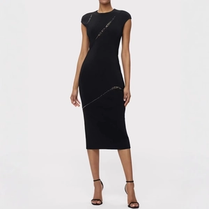 Detailed view of black bandage dress featuring sparkly sequin accents and slim fit cut
