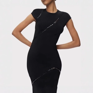 Close-up of black bodycon bandage dress featuring elegant diagonal sparkling rhinestones