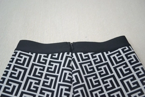 Detailed view of elastic waist and hidden zipper on jacquard maze pattern shorts