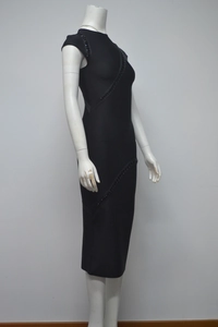 Detail of black bandage dress featuring sparkly rhinestone embellishments and a slim fit