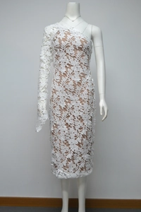 Detail of white lace one-shoulder dress with floral pattern and sheer mesh sleeve