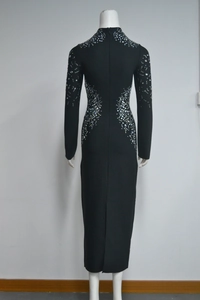 Detailed view of intricate silver rhinestone floral patterns on a black bandage dress