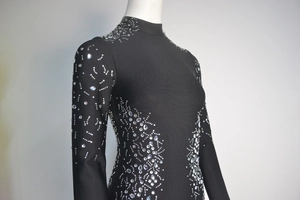 Close-up of black bandage dress showing elegant rhinestones and intricate silver beading