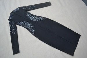 Detail of silver rhinestones and crystal beads on black long sleeve bandage dress