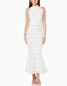 Detail of tiered ruffle hem and halter neckline on a white backless evening party dress