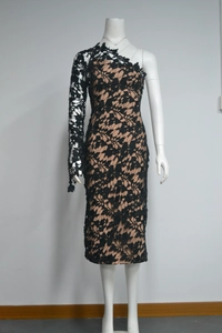 Close-up of elegant black floral lace fabric with a contrast nude lining on dress