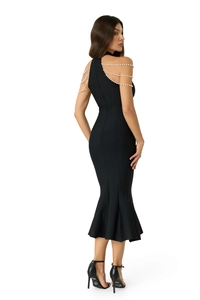 Detail of elegant black bandage mermaid dress with luxury white pearl chain straps