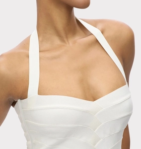 Close-up of elegant white halter bandage dress showing stretch textured fabric