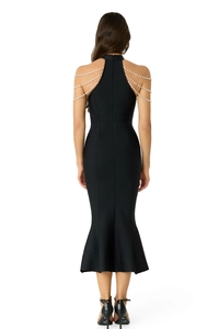 Detail view of the back of a black bandage dress with elegant pearl chain fringe shoulders