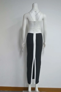 Detail view of the back zipper and slit on a black and white bandage dress