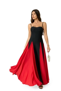 Detail of elegant two-tone pleated skirt featuring vibrant red satin and black panels