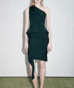 Detail of forest green one-shoulder dress with peplum waist and asymmetrical drape
