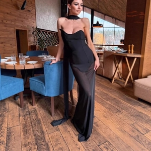 Close-up of elegant black mesh maxi dress with structured corset top and silk scarf detail