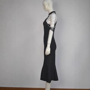 Detail of the multi-layer pearl chain straps on a black sleeveless mermaid bandage dress