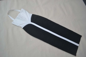 Detail of elegant black and white patchwork bandage dress with vertical stripe texture