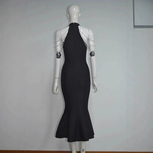 Detail of elegant pearl chain straps on a black sleeveless fishtail bandage dress