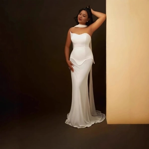 Detailed view of white tube top evening gown with neck-tie and mermaid tail hem