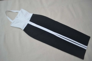 Detail of elegant black and white bandage dress with halter neck and contrast stitching