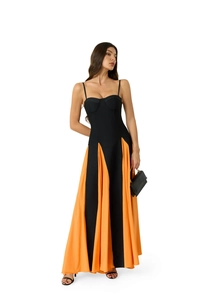Detail of elegant pleated floor-length gown with orange and black vertical contrast stitching