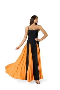 Detail view of the black corset bodice and orange pleated contrast of the maxi dress