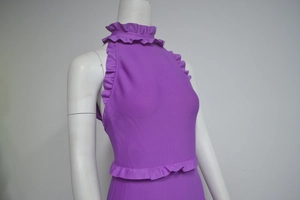 Detailed close-up of purple high-neck dress with layered ruffle trim on sleeves and waist
