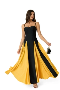 Detail view of contrast patchwork maxi dress with black bodice and yellow flared skirt