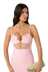 Detail of pink bandage dress showing asymmetric collar and sheer mesh V-panel waist