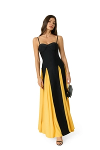 Detail of slim fit maxi dress featuring contrast black bodice and yellow chiffon hemline