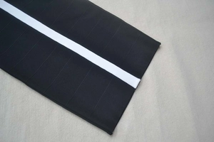 Macro detail of high-density composite fabric with precise stitching and white webbing