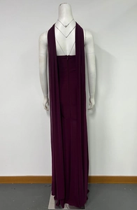 Detail view of the burgundy floor-length dress showing the back zipper and trailing cape