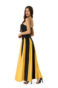 Detail of elegant two-tone black and yellow floor-length dress with a slim-fit silhouette