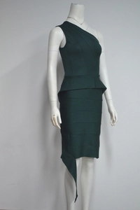 Detail of dark green one-shoulder bandage dress with peplum waist and asymmetric hem