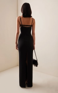 Detail view of back cross-straps, black mesh paneling, and high slit on slim fit long dress