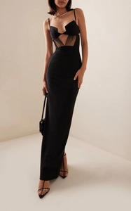 Close-up of black bodycon dress with sheer mesh paneling and deep V-neckline detail