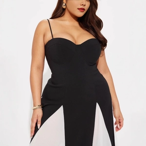 Detailed view of slim-fit black strap dress with elegant white contrast hem splicing