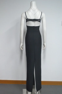 Detail view of the backless cutout design and rear slit on a black slim fit maxi dress