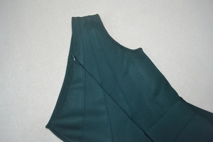 Detail of dark green bandage dress with invisible side zipper and diagonal stitching