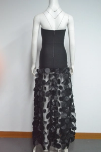 Detail view of the black strapless evening dress back showing zipper and 3D applique mesh