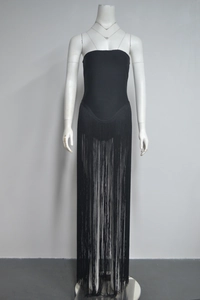 Detailed view of the layered black fringe tassels on a strapless bandage dress