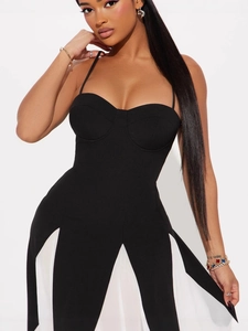 Detailed view of black and white contrast dress with corset bodice and spaghetti straps
