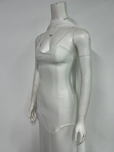 Detailed view of white bodycon evening dress featuring thin straps and deep U-neckline