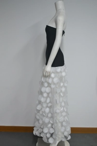 Detail of 3D floral petals on a high-contrast black and white strapless evening dress
