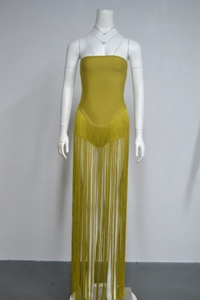 Macro view of long mustard yellow fringe detailing on a strapless bandage dress