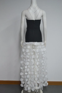 Detailed back view of a strapless evening dress with 3D floral petals and back zipper