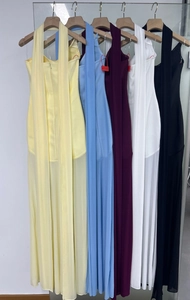 Detail of elegant backless halter dresses in five pastel and classic colors on hangers