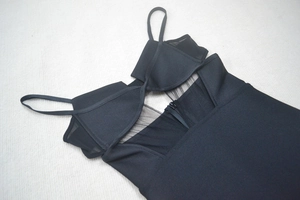 Close-up of black bodycon dress with sheer mesh paneling and thin shoulder straps