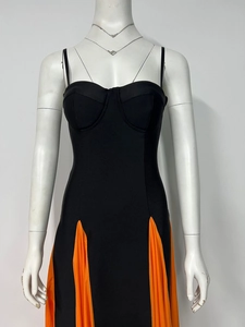 Detail of heart neckline and orange pleated contrast hem on slim fit bandage dress