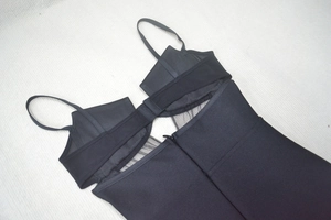 Detail of black deep V-neck bandage dress showing mesh patchwork and hidden zipper