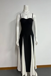 Detail view of a black and white contrast slim-fit maxi dress on a display mannequin